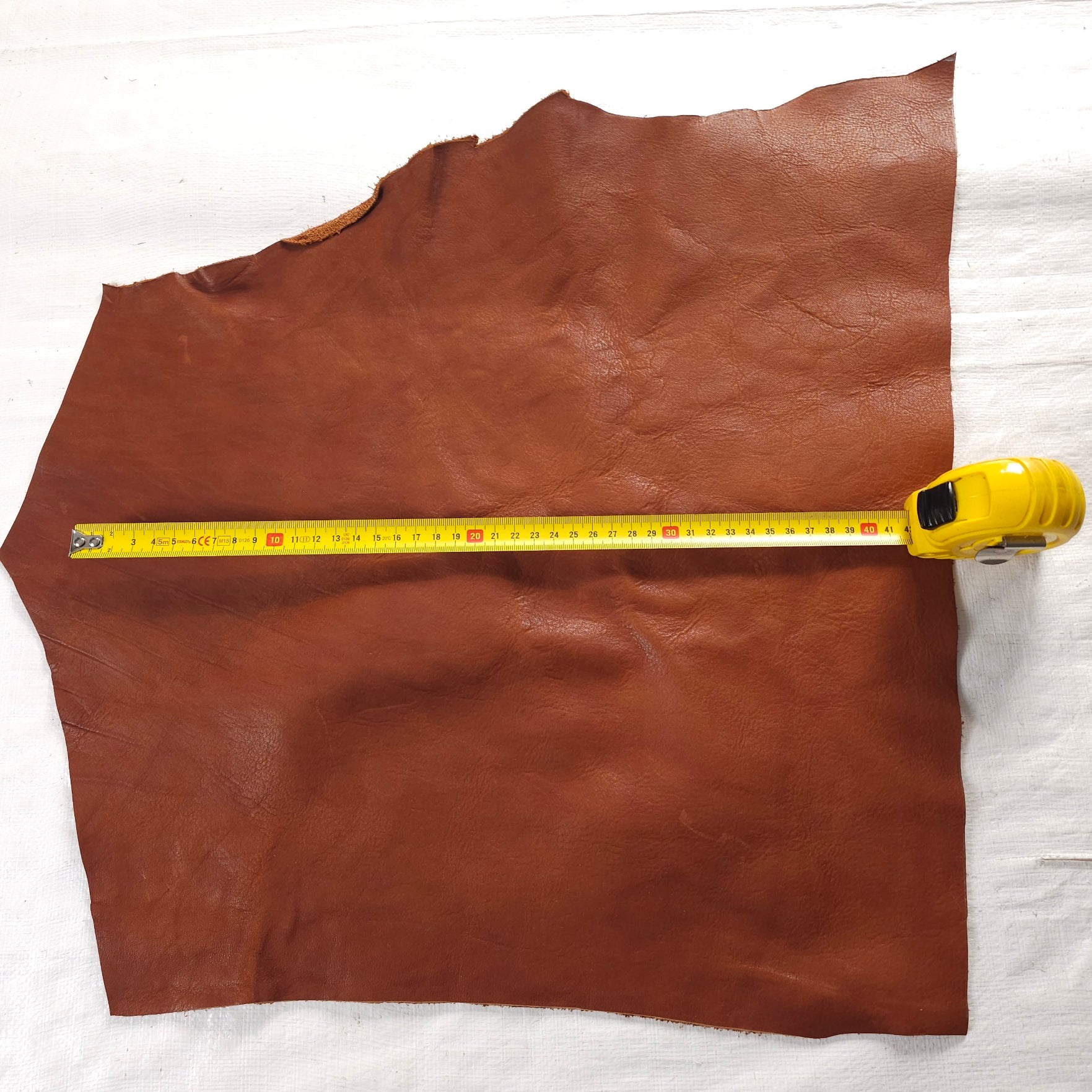 Vegetable-tanned leather scraps in Forest Green and Tan, varying shapes and textures.
