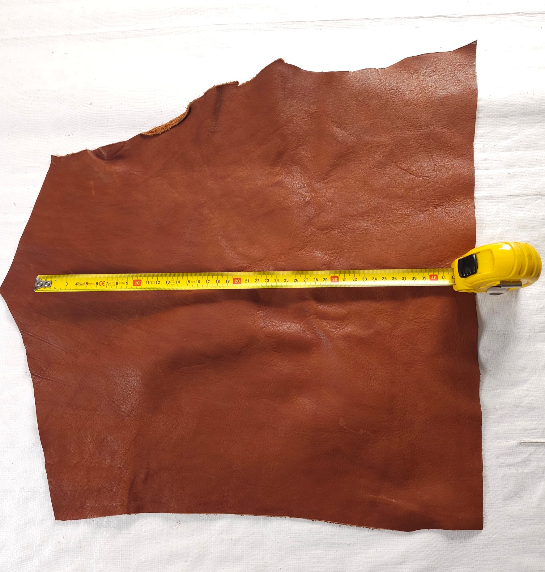 Vegetable-tanned leather scraps in Forest Green and Tan, varying shapes and textures.
