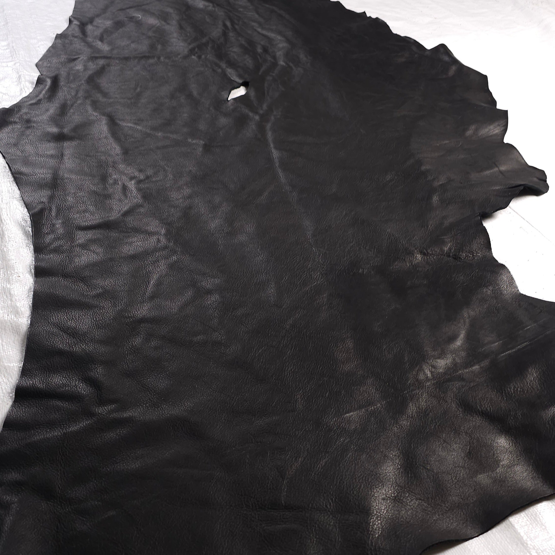 Black leather offcuts with natural scars and marks