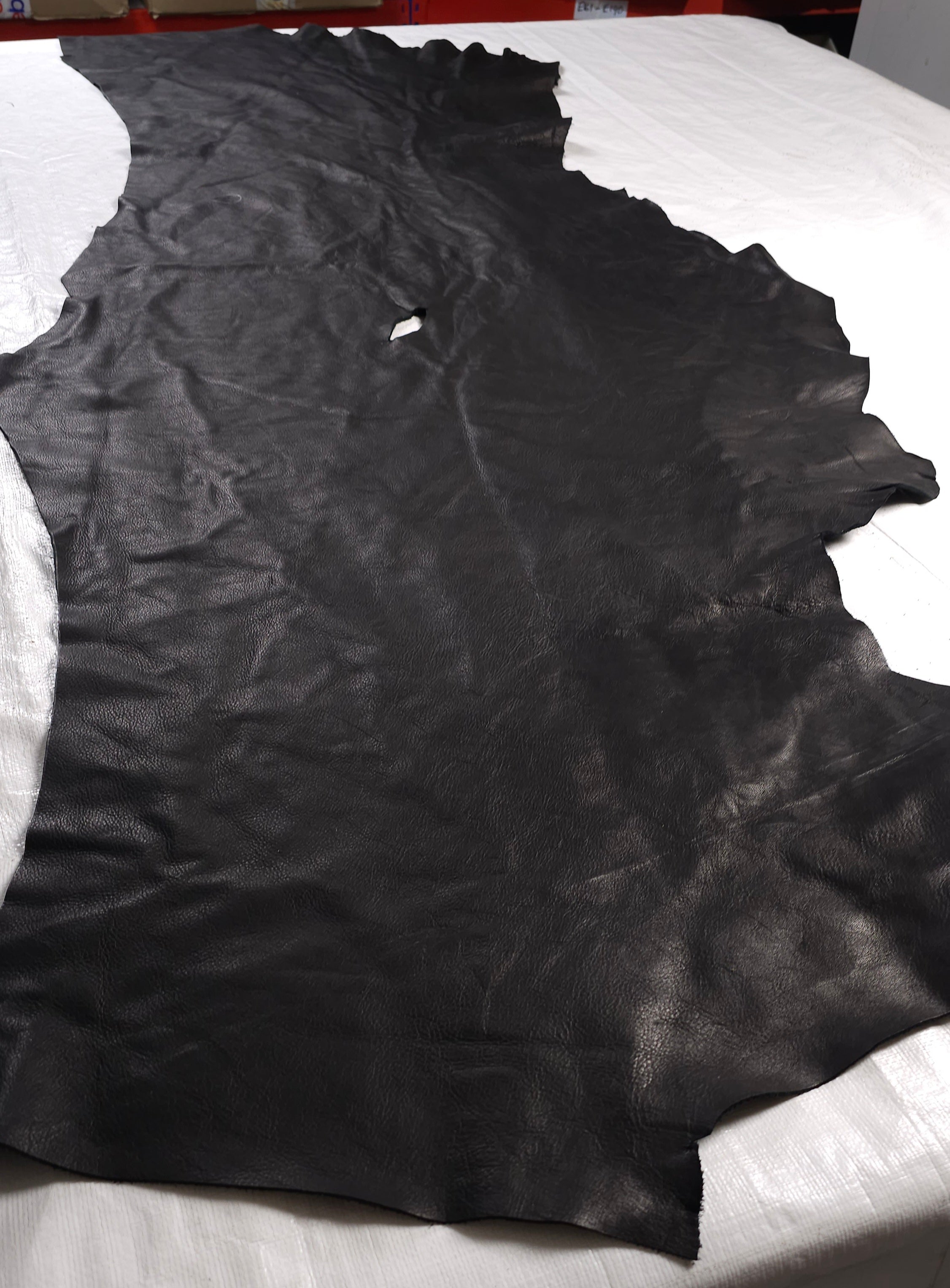 Black leather offcuts with natural scars and marks