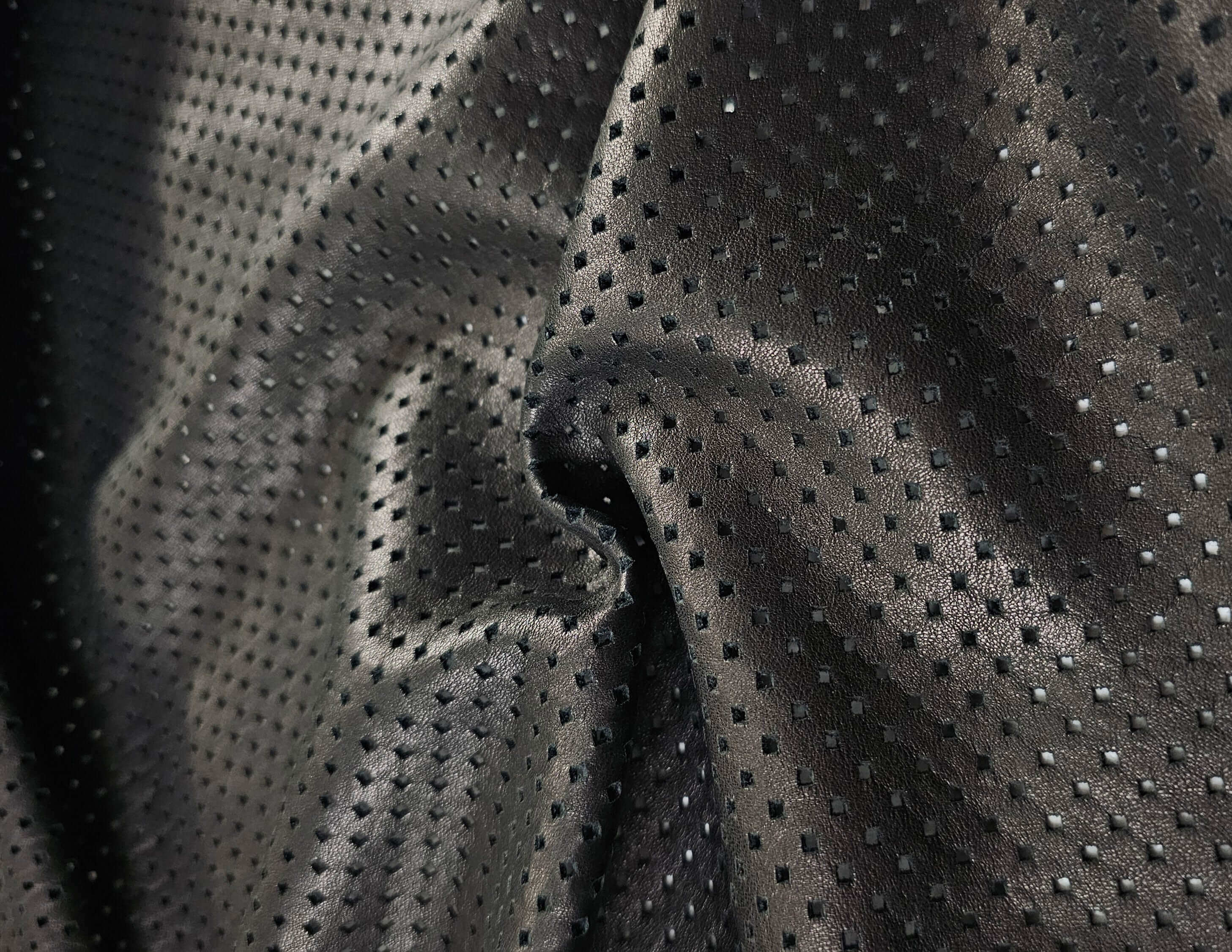 Closeup of Soft Black perforated sheepskin Leather Stock Lots 14 sq. ft