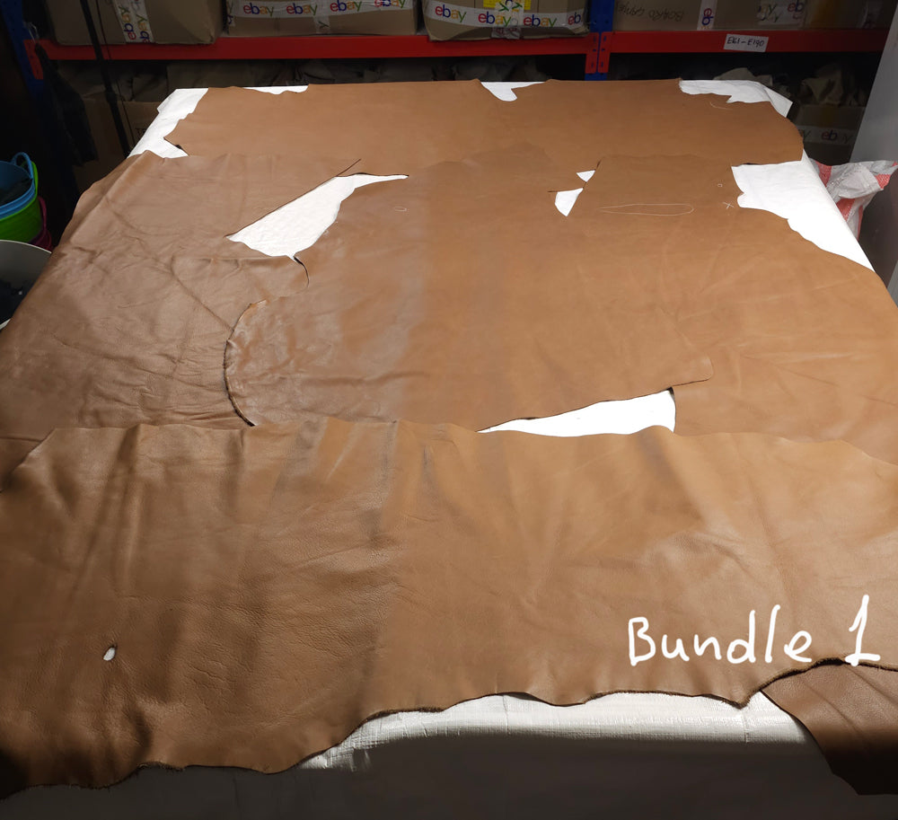 Assorted cowhide upholstery scrap pieces in warm brown shades