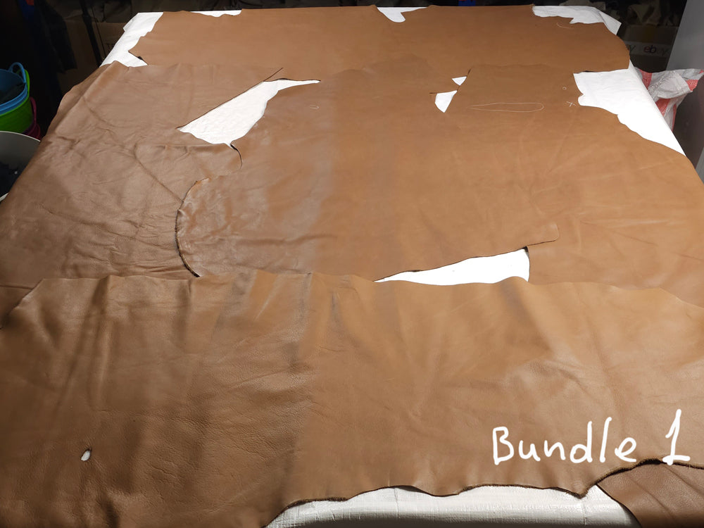 Assorted cowhide upholstery scrap pieces in warm brown shades