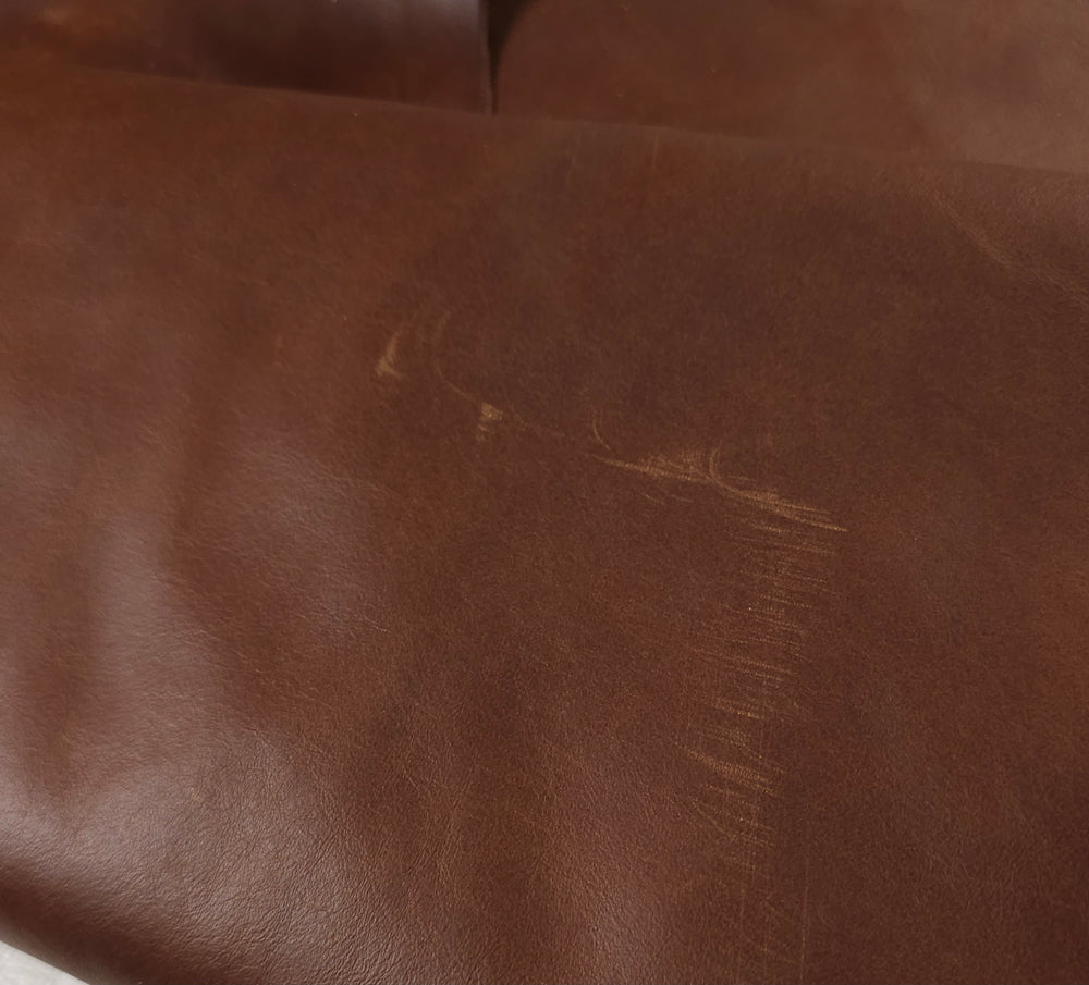Minor small scratches  in Cuba cowhide upholstery