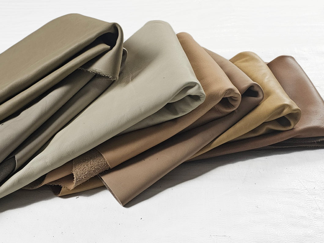 Assorted full-grain leather offcuts in earth tones and greens