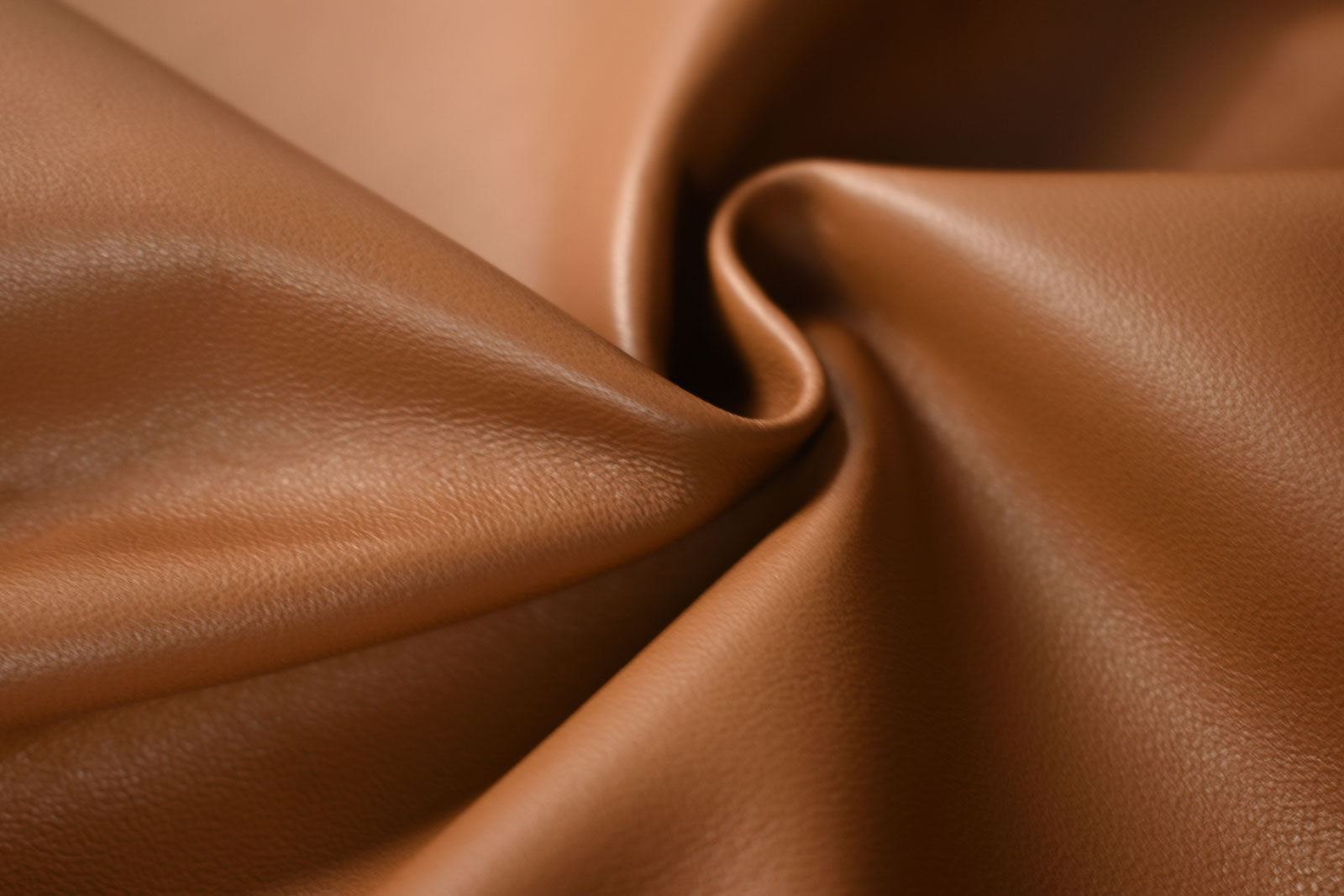 Saddle Tan Lambskin hides, a close-up of buttery soft brown leather. Ideal for couture fashion and crafting projects. 8-10 sq ft sizes available.